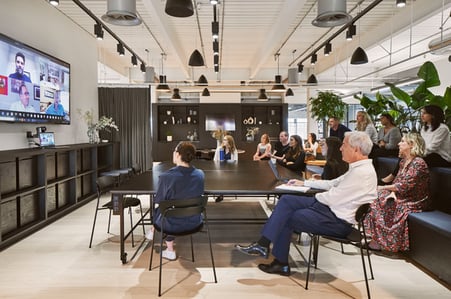Employees having a virtual meeting in an office
